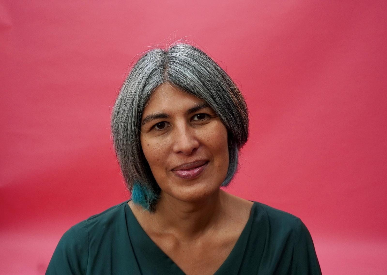 A person with grey hair and a green shirt
AI-generated content may be incorrect.