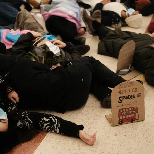 Trans activists stage ‘die-in’ at Victoria Station to protest government’s ban on puberty blockers