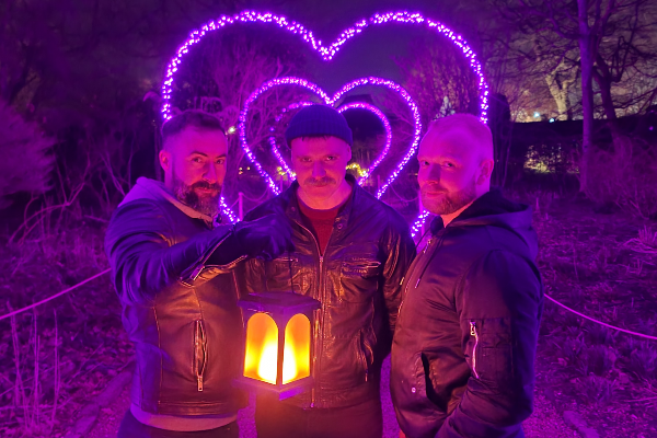 Ignite at Nymans Gardens, three men in the tunnel of love with a lantern in the dark