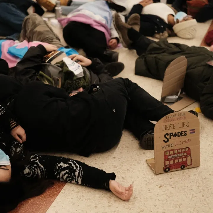 Trans activists stage ‘die-in’ at Victoria Station to protest government’s ban on puberty blockers