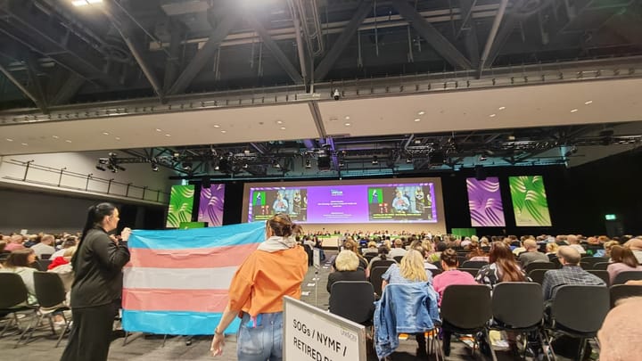 Trans delegates fly trans flags and banners during Unison health conference attended by Labour Health Secretary Wes Streeting
