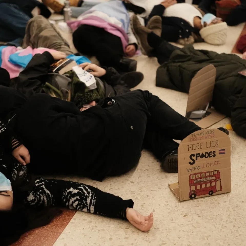 Trans activists stage ‘die-in’ at Victoria Station to protest government’s ban on puberty blockers