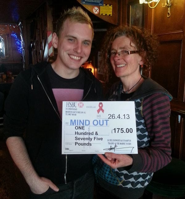 Helen Jones director of MindOut receives cheque for £175 from Jamie Jones at the Marine tavern