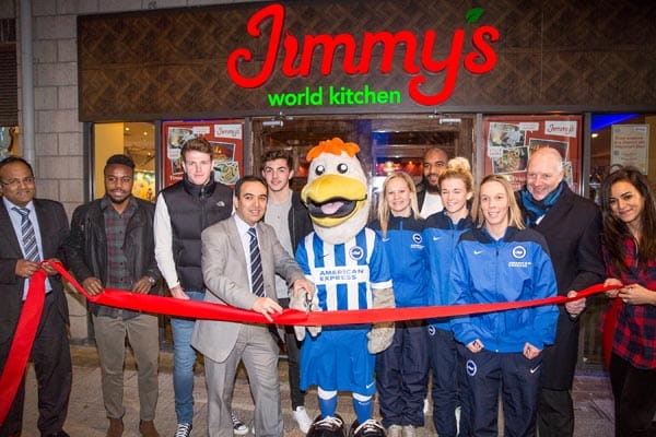 Area manager Mukesh cuts the ribbon watch by players from the Albion and restaurant staff