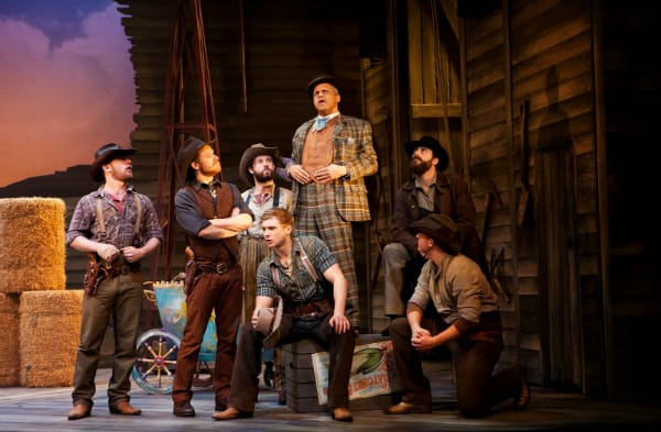 Gary Wilmot as Ali Hakim (centre) with the cast of the National tour of OKLAHOMA! credit Pamela Raith