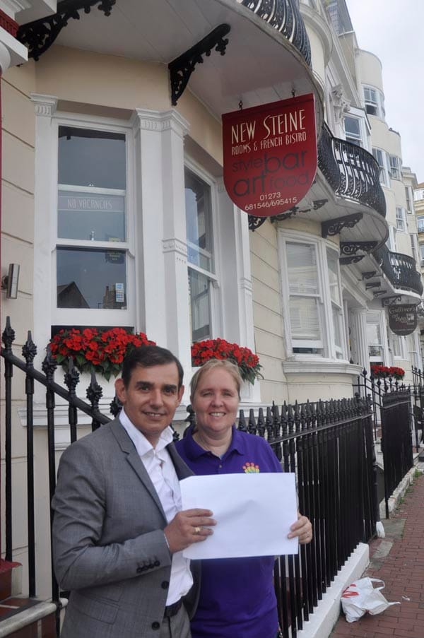 Herve Guyet hand paperwork for two new wheelchairs to AJ Paterson