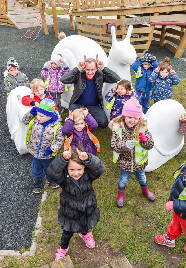 Children from the Pumpkin Patch nursery meet one of the snails and Norman Cook. Image Simon Dack/Vervate
